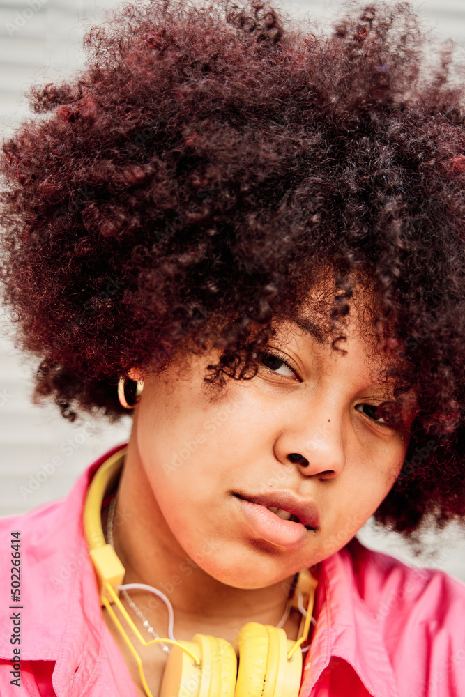 close-up of an African-American woman with curly hair looking at camera. close-up of an African-American woman with curly hair looking at camera.