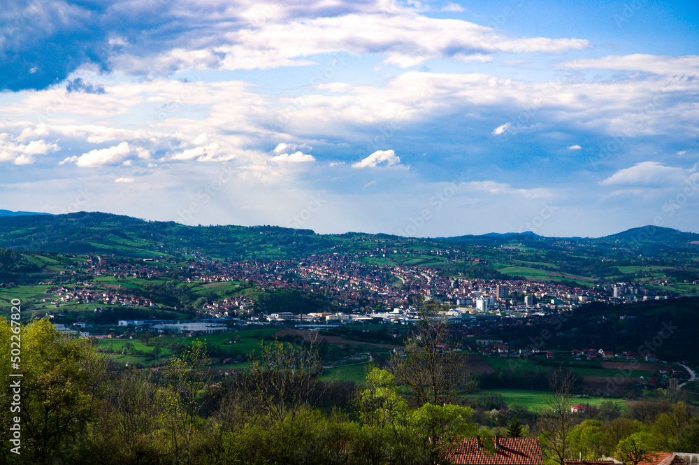 Fototapeta premium Landscape with mountains and houses.