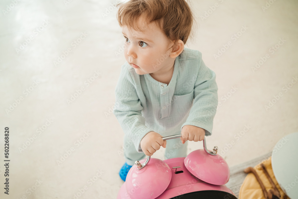 toddler plays with big pink alarm clock toddler plays with big pink alarm clock