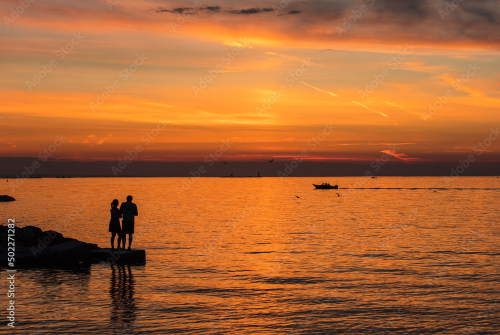 Couple enjoys a romantic sunset view in Collingwood waterfront park in summer
