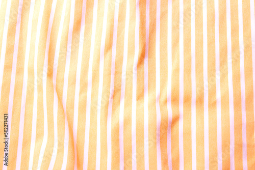 Beautiful yellow fabric with white stripes background. Draped background of fabric, texture. Abstract background