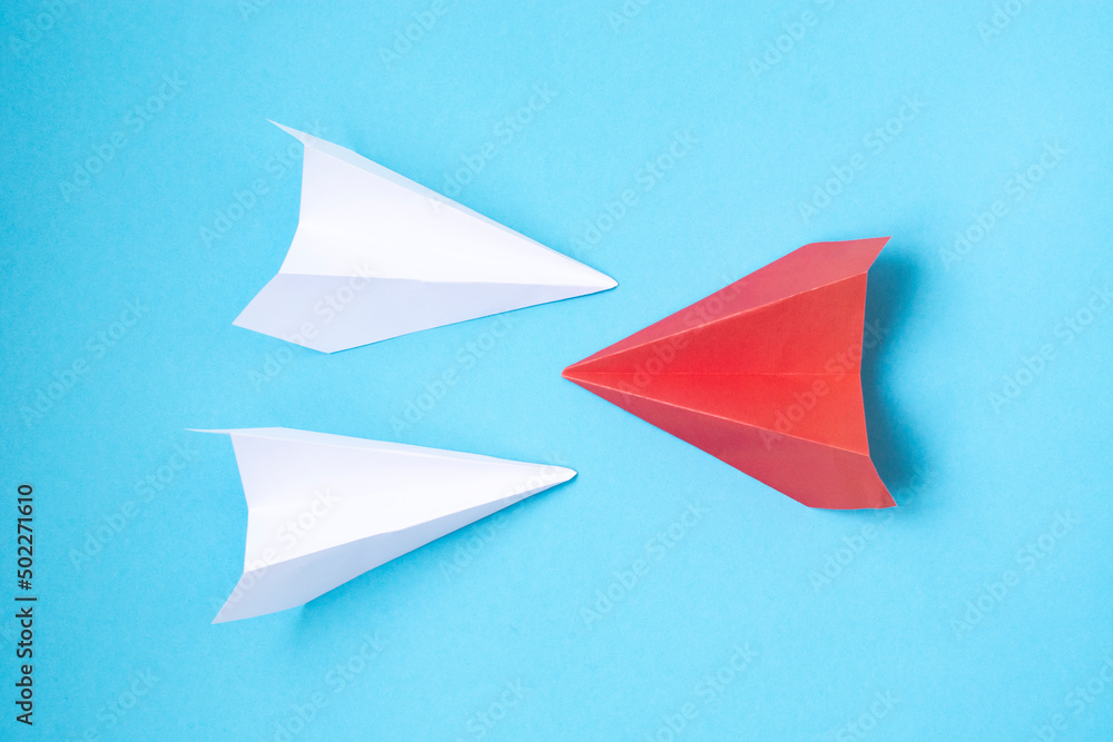 Red paper plane changing direction from white paper plane on blue background. business concept for new ideas creativity Red paper plane changing direction from white paper plane on blue background. business concept for new ideas creativity