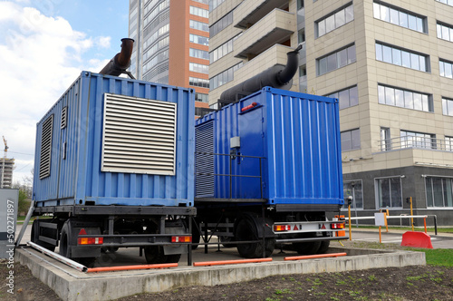 Industrial mobile diesel generator. Industrial diesel generator for an office building, connected to the electrical network by a cable.