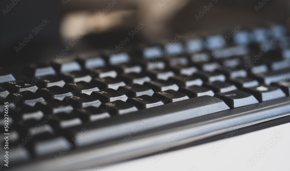 Simple generic black business office computer keyboard object detail, shallow dof, closeup, nobody. Abstract background, no people. Workplace, corporate business place of work, desk, writing concept Simple generic black business office computer keyboard object detail, shallow dof, closeup, nobody. Abstract background, no people. Workplace, corporate business place of work, desk, writing concept
