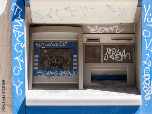 Old damaged destroyed vandalised outdoor ATM, vandalized cash machine detail, closeup. Economical crisis, financial recession, riots, global business issues, poverty abstract concept, nobody