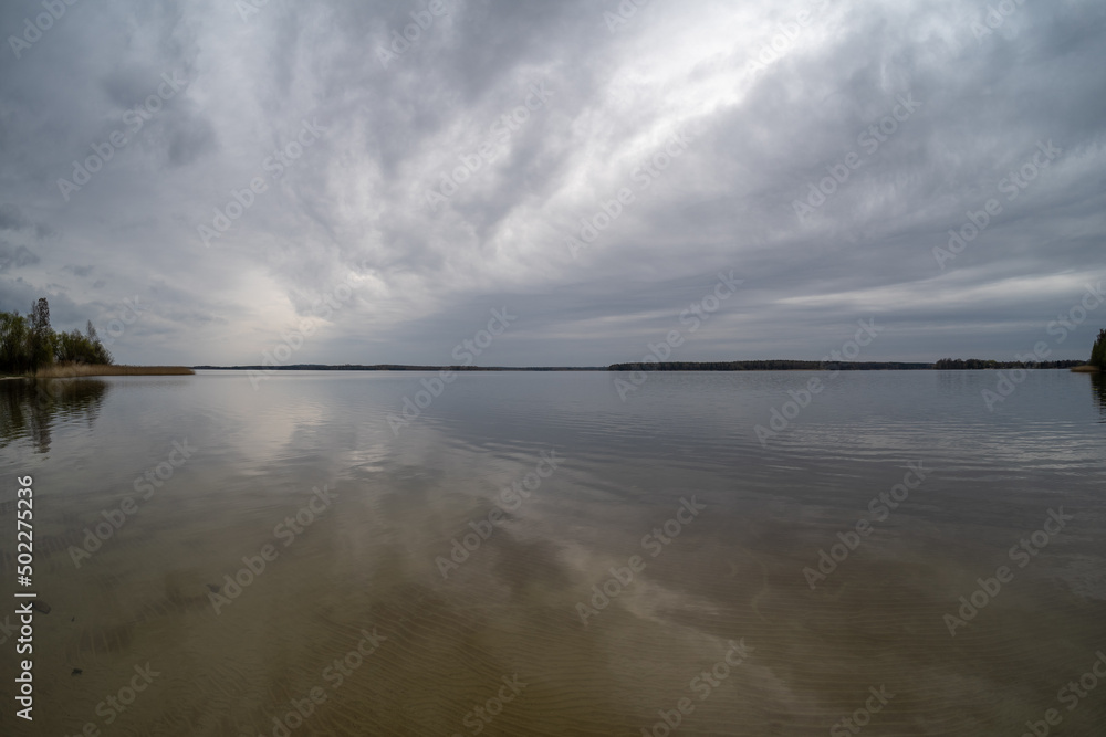 The calm water surface in cloudy weather.