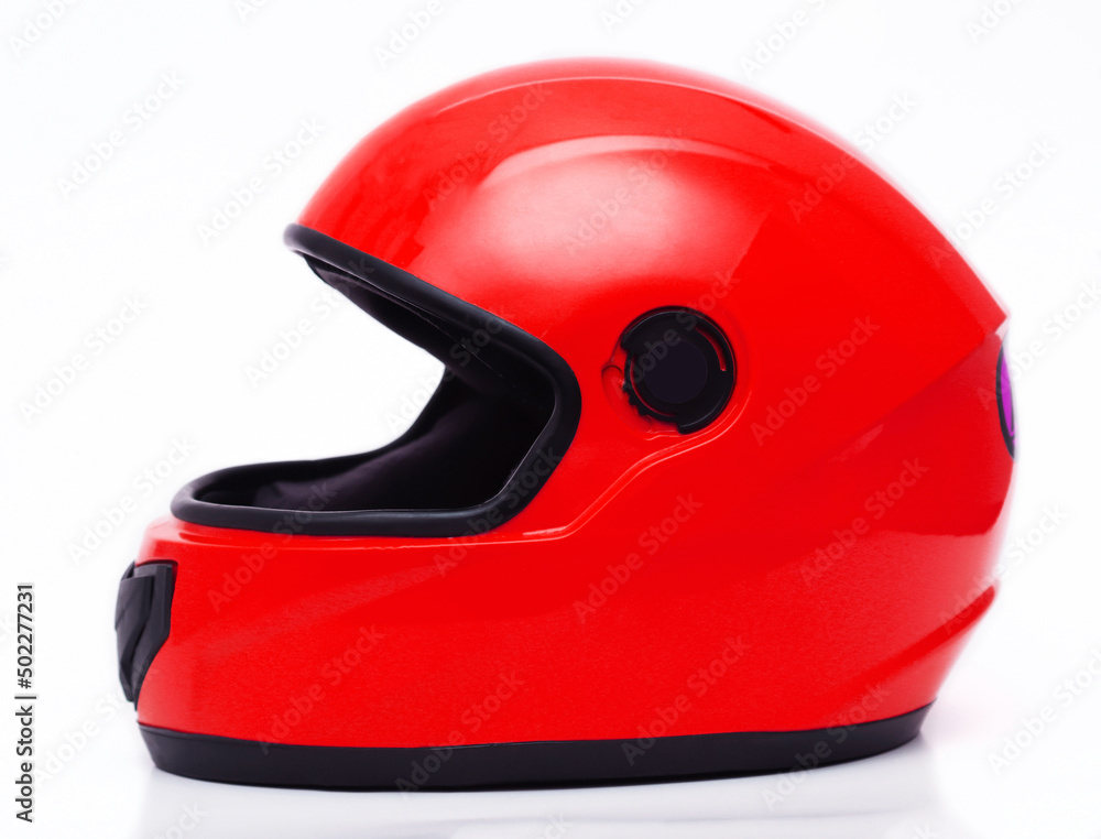 Fototapeta premium Car helmet in red color on a white background. Close-up