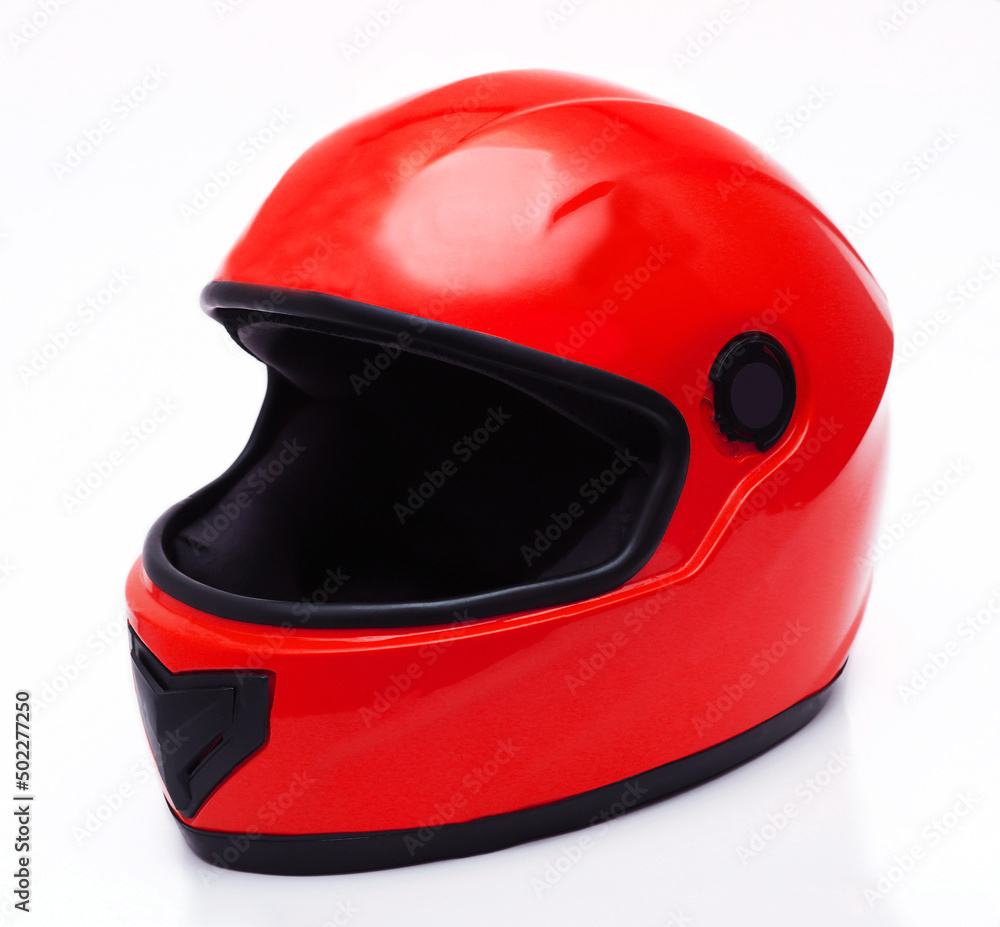 Fototapeta premium Car helmet in red color on a white background. Close-up