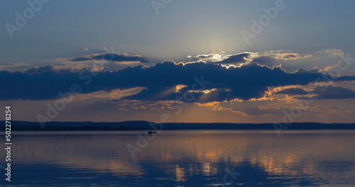 Sunset over lake. clouds. Water. San in the sky. © Media Whale Stock