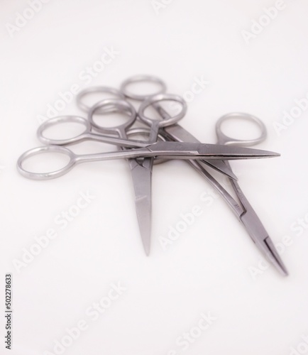 Bunch of surgical scissors on a white background ,shallow depth of field image. photo