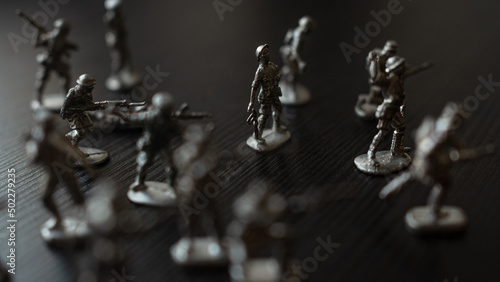 The concept of war and confrontation, political crises, toy tin soldiers attacking each other photo