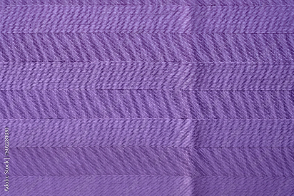 Fototapeta premium Soft pastel satin with jacquard weave. Dense purple fabric texture closeup. Natural cotton bedding. Bed sheet background.