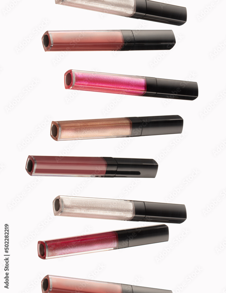Liquid lipstick of various colors falls on a white background
Liquid lipstick of various colors falls on a white background