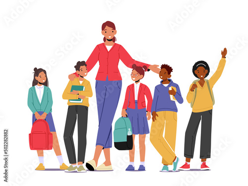 Back to School Concept with Young Smiling Woman Teacher and Group of Kids Stand in Row in Classroom. Elementary School