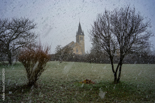 Saint Didier church under the snow, in Rignat, department of Ain, France. photo