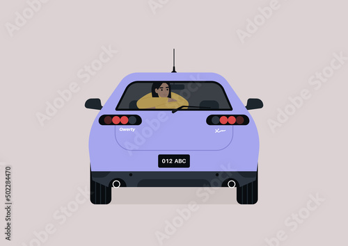 A young female passenger seating on the backseat of a sedan car