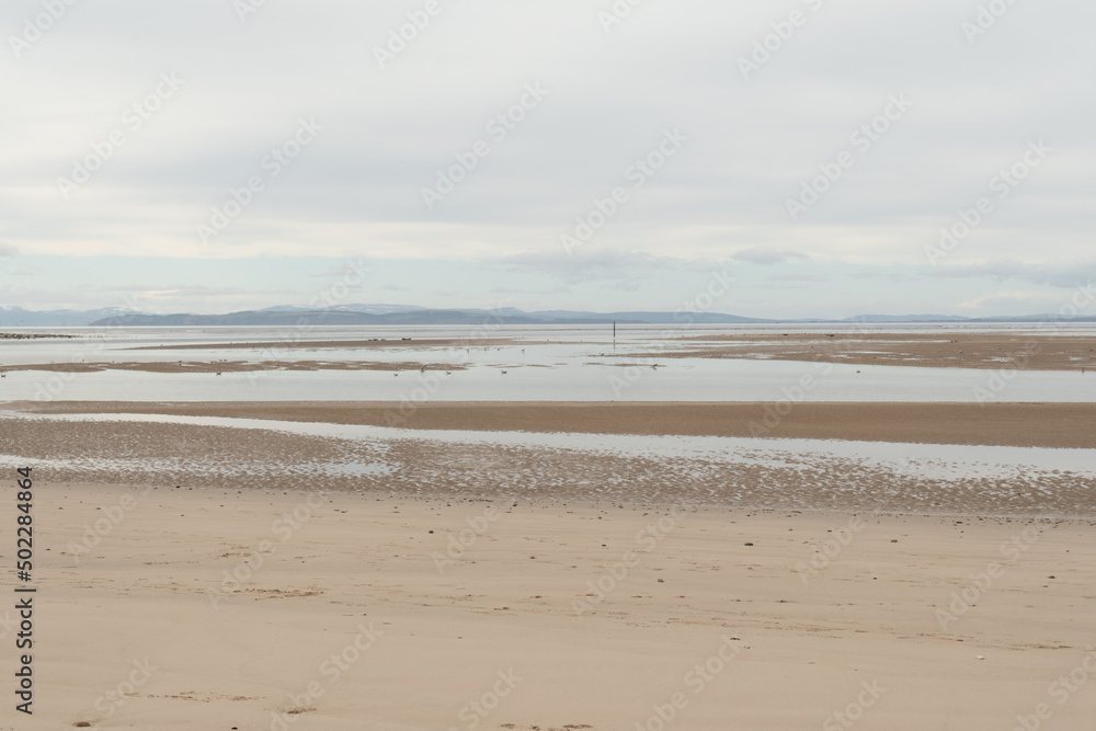 Findhorn beach in Scotland. Findhorn is a village in Moray, Scotland. It is located on the eastern shore of Findhorn Bay and immediately south of the Moray Firth.