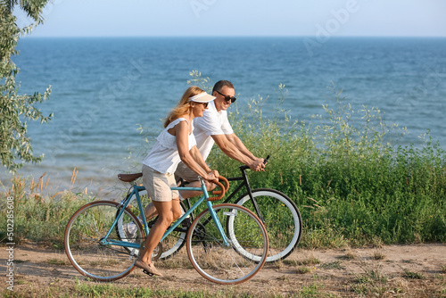 Mature couple riding bicycl...