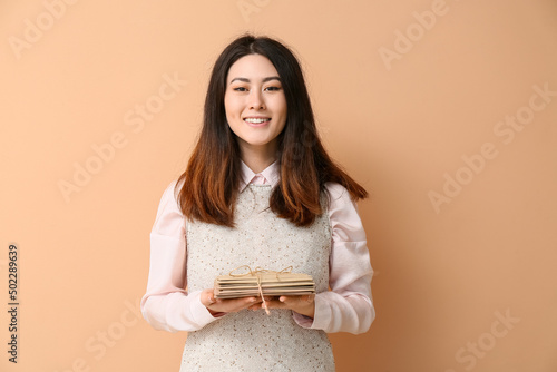 Young Asian woman with stac...