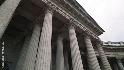 Colonnade with corinthian orders of ancient building. Action. Bottom view of beautiful white columns of old building. Colonnade of Kazan Cathedral in Saint Petersburg