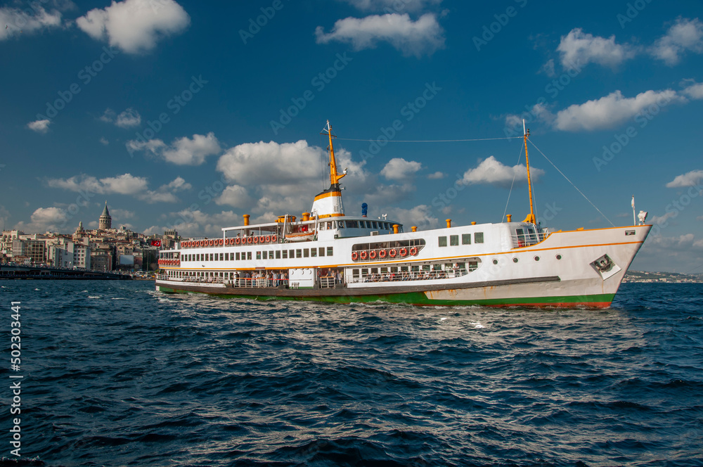view of passenger ferry in golden horn and cloudy blue sky in back