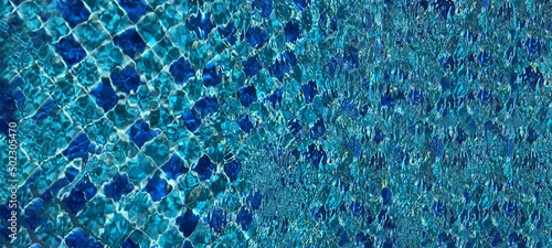Abstract checkered blue light blue background. Wallpaper, backdrop. Creative idea. Art photo, conceptual illustration. View of swimming pool close-up. Ripples on the surface of the water. Transparent 