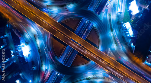 Aerial view of car traffic transportation above circle roundabout road of Drone aerial view fly , high angle. Public transport or commuter city life concept of economic and energy, infrastructure