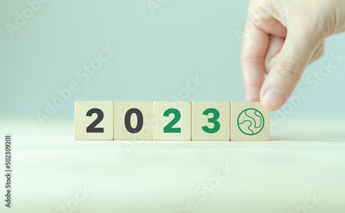 Green business, enviromental sustainability in 2023. Happy new year 2023.  Starting to new year.  2023 written on wooden cubes with smart background. Goals,plan,opportunity and new business or life.