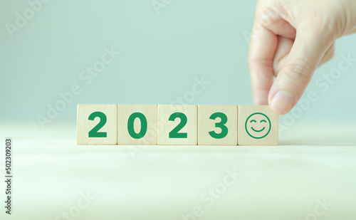 Happy new year 2023.  Starting to new year. 2023 written on wooden cubes with smart background. .Happy people for better of living. Green community. Goals, plan, opportunity and new business or life.