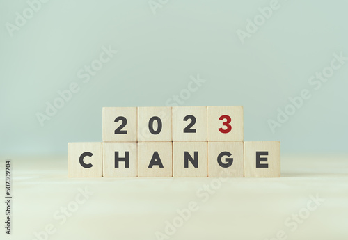 Changing concept in new year 2023 . New business changing, opportunities and decision. Wooden cubes 2023 with text "CHANGE" on smart background and copy space. Magic happens. Digital transformation.