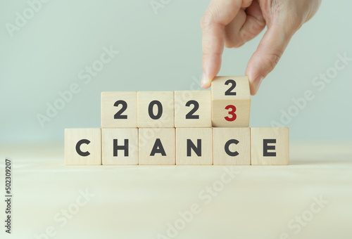 Fototapeta Naklejka Na Ścianę i Meble -  Chance concept for business or life in 2023. Hand flips the wooden cubes  2022 to 2023 with text 