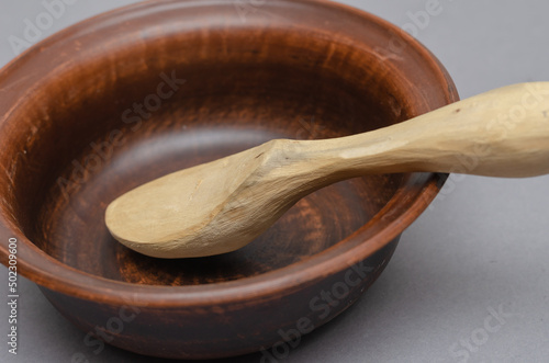 Canvas Print Brown earthenware bowl and buckshot against a gray background.