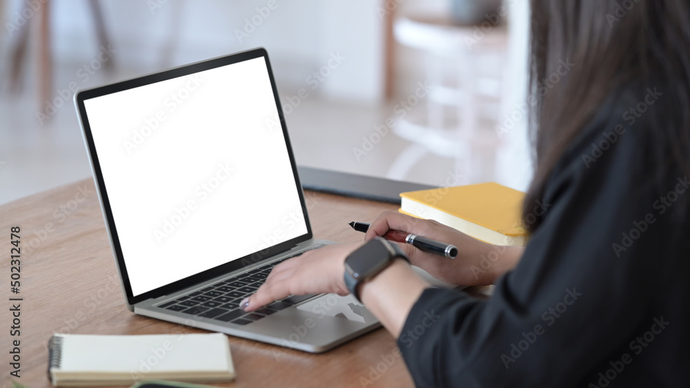 Cropped image of female office worker using laptop computer. Empty screen for advertising text. Cropped image of female office worker using laptop computer. Empty screen for advertising text.