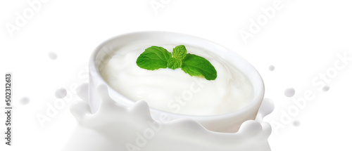 Natural Yoghurt in bowl falling into fermented milk splashed isolated on white background, The movement of Organic dairy products, Healthy drink probiotic, Ketogenic diet food for health care concept.