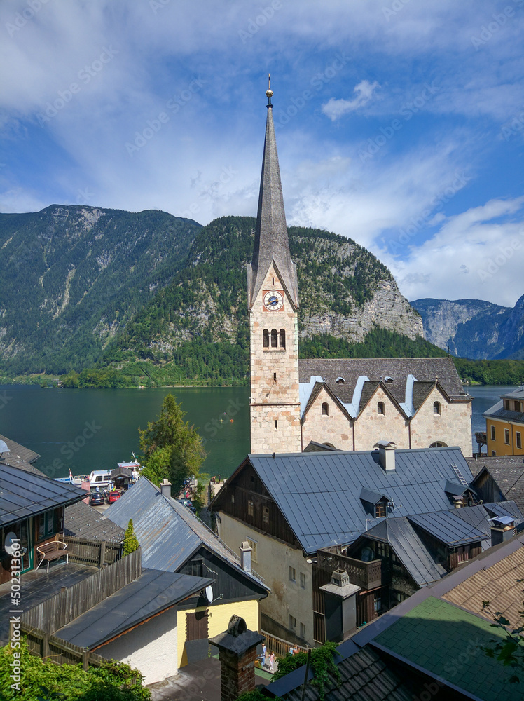 Beautiful view of the city of Hallstatt against the backdrop of the green Austrian Alps and the lake. Vertical. Salzkammergut region, Austria