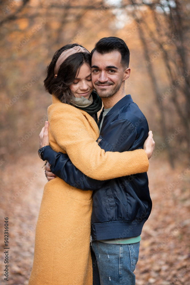 .the guy hugs the girl in the autumn fores .the guy hugs the girl in the autumn fores