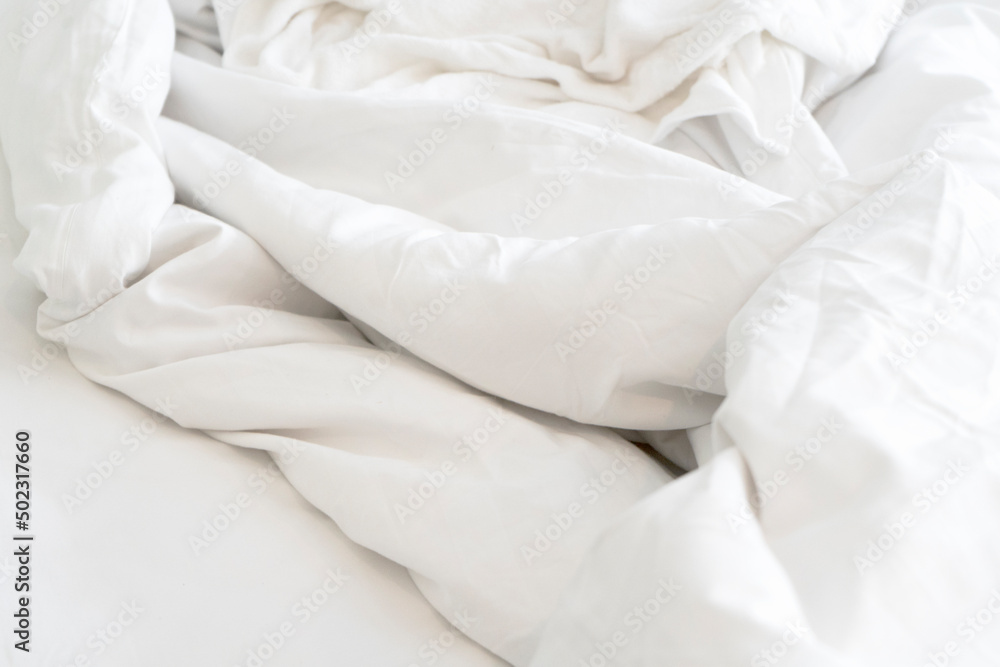 Top view of the crease of an unmade bed sheet in the bedroom after a long night sleep and waking up in the morning Top view of the crease of an unmade bed sheet in the bedroom after a long night sleep and waking up in the morning