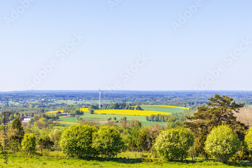 Landscape view at a cultivated land with a wind turbine
