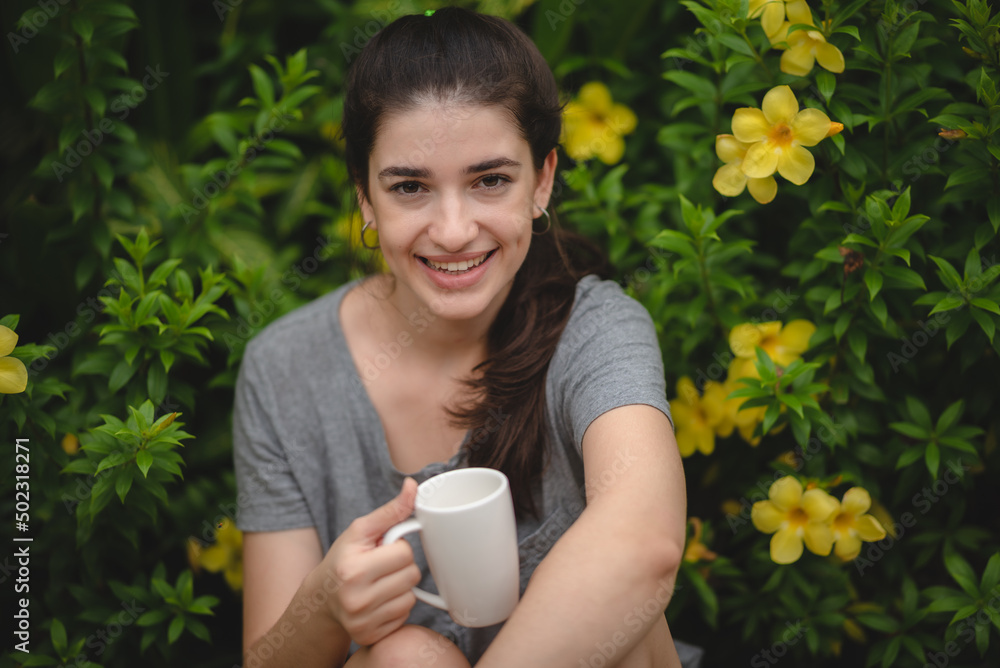young beautiful woman person are happy and enjoy with coffee drink in the morning at home, relax lifestyle by holding coffee or tea cup at nature outdoor park, smile pretty girl with freedom time young beautiful woman person are happy and enjoy with coffee drink in the morning at home, relax lifestyle by holding coffee or tea cup at nature outdoor park, smile pretty girl with freedom time