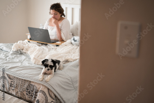 Woman seen working on her laptop from home