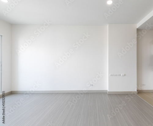 Bright empty interior with two large window, city view and blank gray wall.