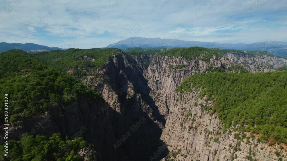 Aerial view on high rocky mountains with green forest on top and blue sky over. Amazing landscape of turkish nature. Aerial view on high rocky mountains with green forest on top and blue sky over. Amazing landscape of turkish nature.