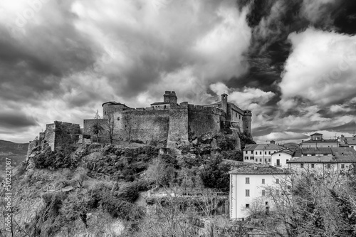 Black and white view of Bardi Castle, Parma, Italy, under a dramatic sky photo