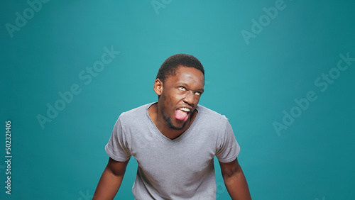 Canvastavla Silly goofy man fooling around and sticking tongue out on camera, acting crazy and childish