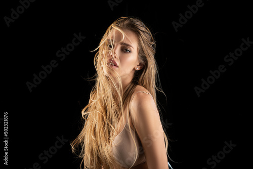 Beautiful woman with shiny hair. Beauty face of young girl. Sexy female model posing in studio. Advertising for a beauty salon.