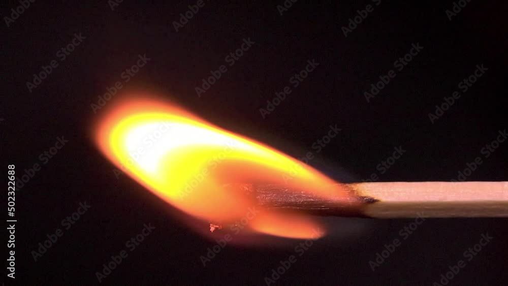 A lighted match gets blown out by the wind - slow motion A lighted match gets blown out by the wind - slow motion