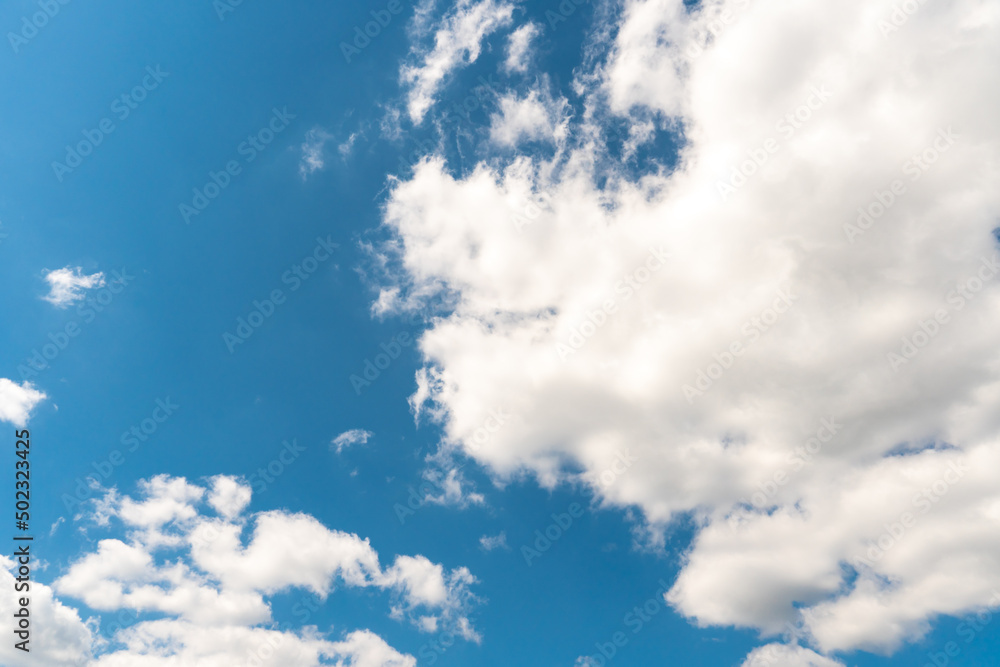Obraz premium Beautiful white fluffy clouds slowly float against the blue sky on a warm sunny summer day. Timelapse video of cloud movement high quality 4k.