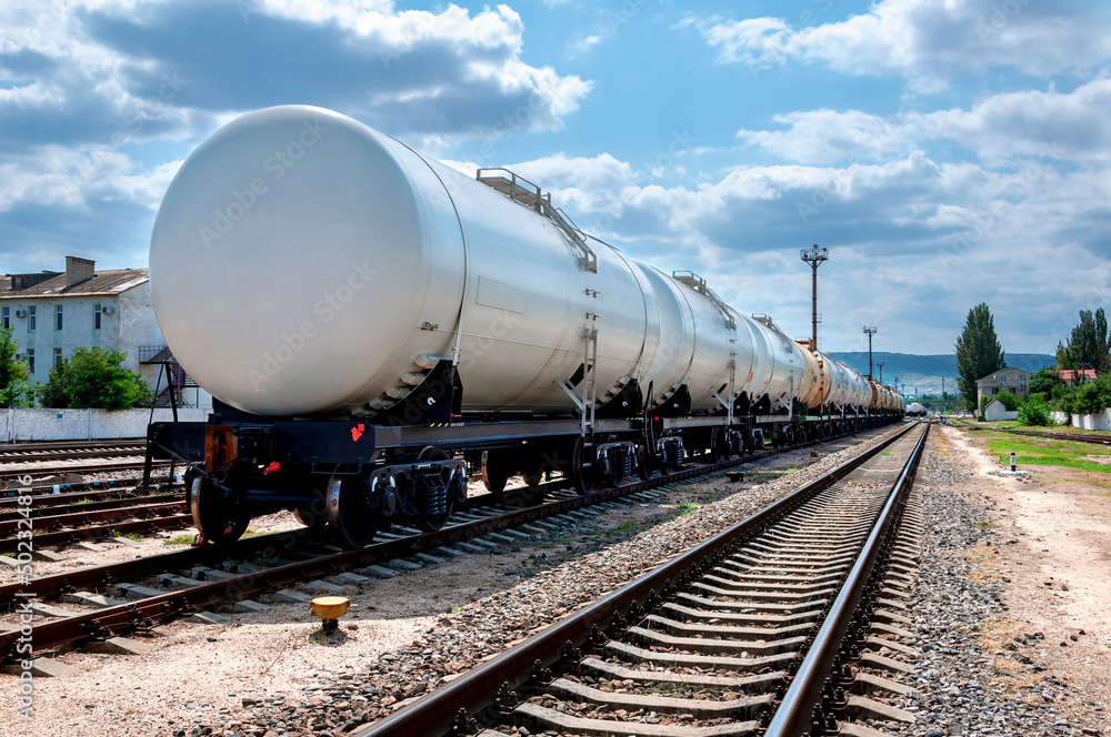 Naklejka premium The train with tank cars stands on the tracks at the station.