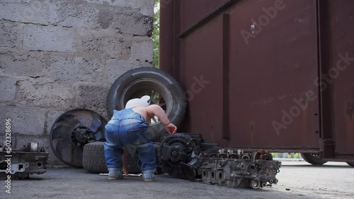kid mechanic dances and takes the wrench, then turns to camera