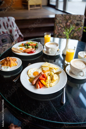 Delicious Breakfast for Two at the Luxury Hotel  Eggs  Sausages  Vegetables  Croissants Coffee  Orange Juice